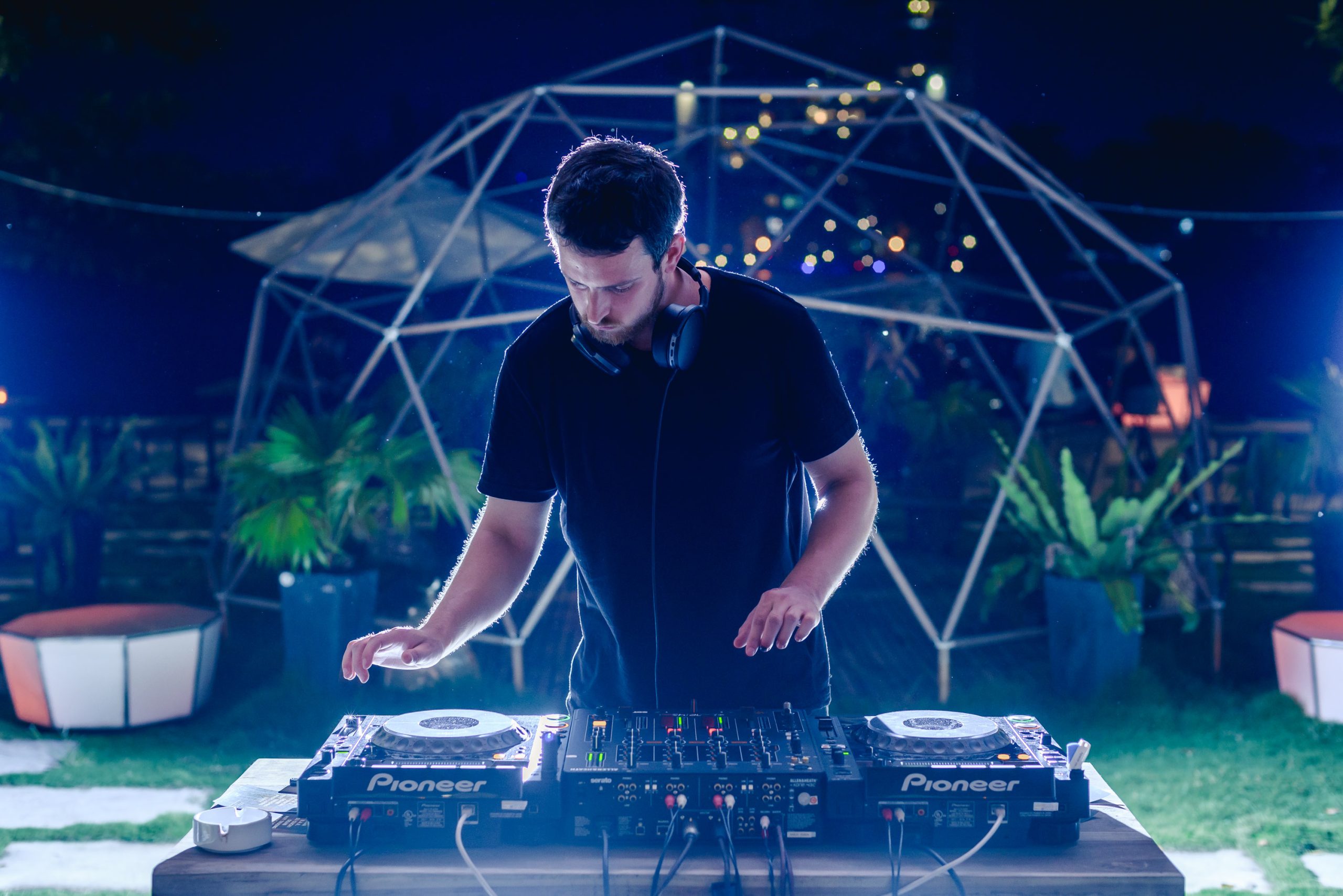 Irish DJ and producer Hugh Def performing at an event in Hanoi, Vietnam on Pioneer CDJs and mixer, colour image.