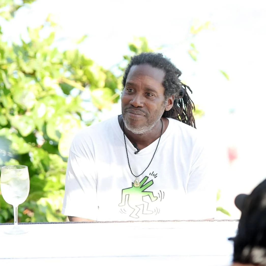 British DJ and producer Bert Bevans sitting at table with glass of wine in Bali, colour image.