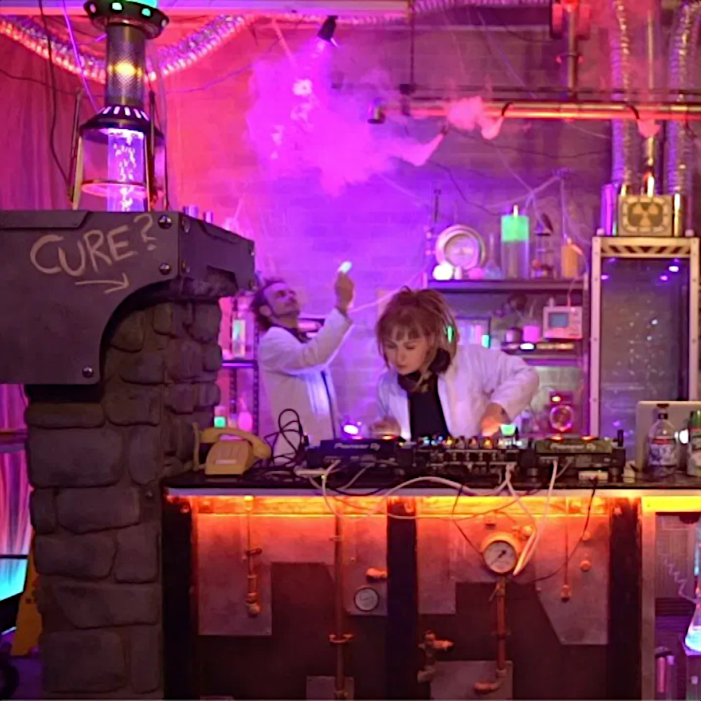 Australian DJ Jangala performing at an event in a venue that looks like a laboratory from a horror movie, colour image
