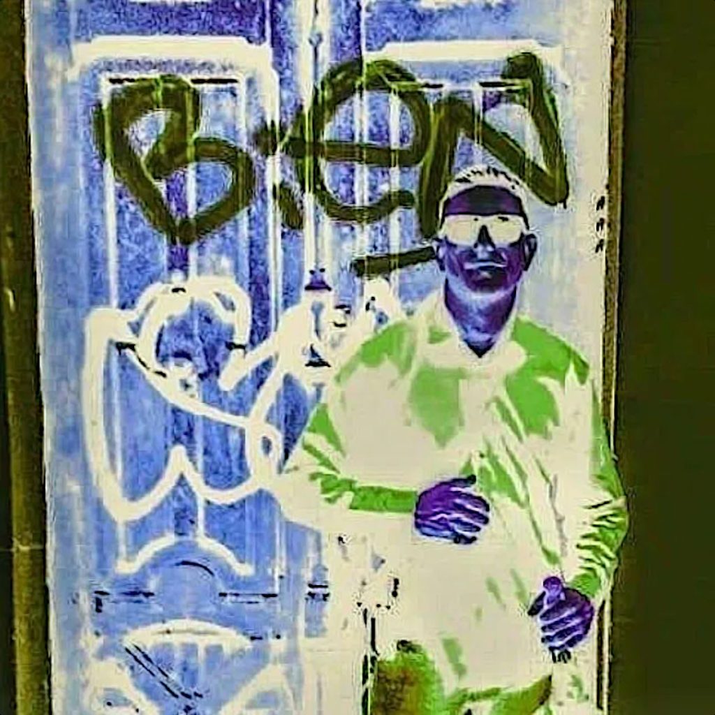 British DJ and Producer Breed Intel a.k.a Alexander McCann standing against a graffiti door in inverted colour image, colour image.