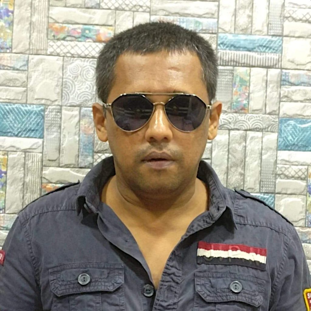 Indian DJ and producer Psy Inertia wearing aviator sunglasses in upper body shot, colour image.