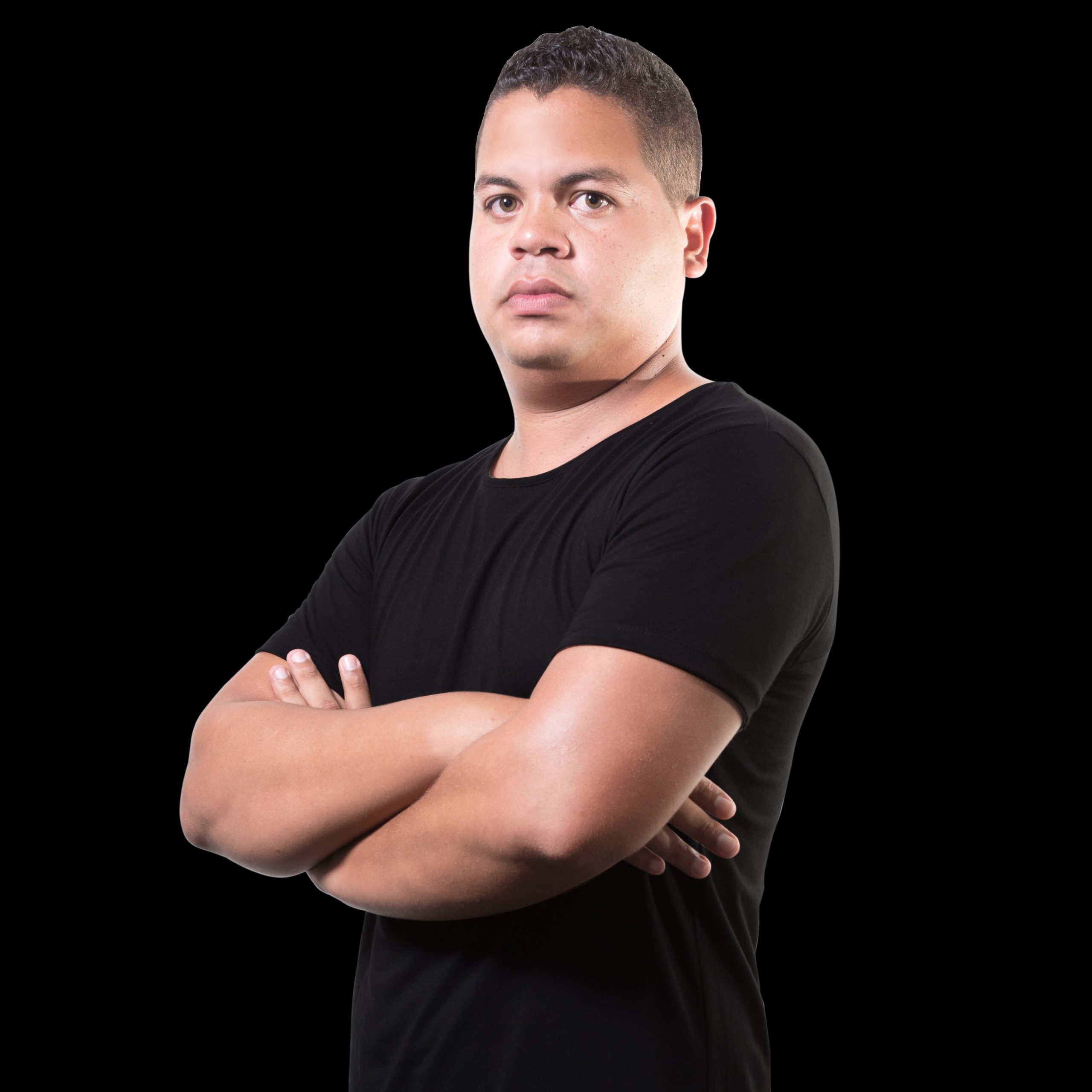 Nhà DJ người Venezuela JC Will, còn được biết đến với nghệ danh Jefry Figuera, đứng khoanh tay nhìn về phía máy ảnh trên nền đen, hình ảnh màu.