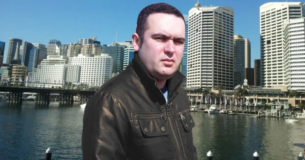 Portuguese DJ Joshua standing in front of the rail at Darling Harbour, Sydney, Australia, colour image.