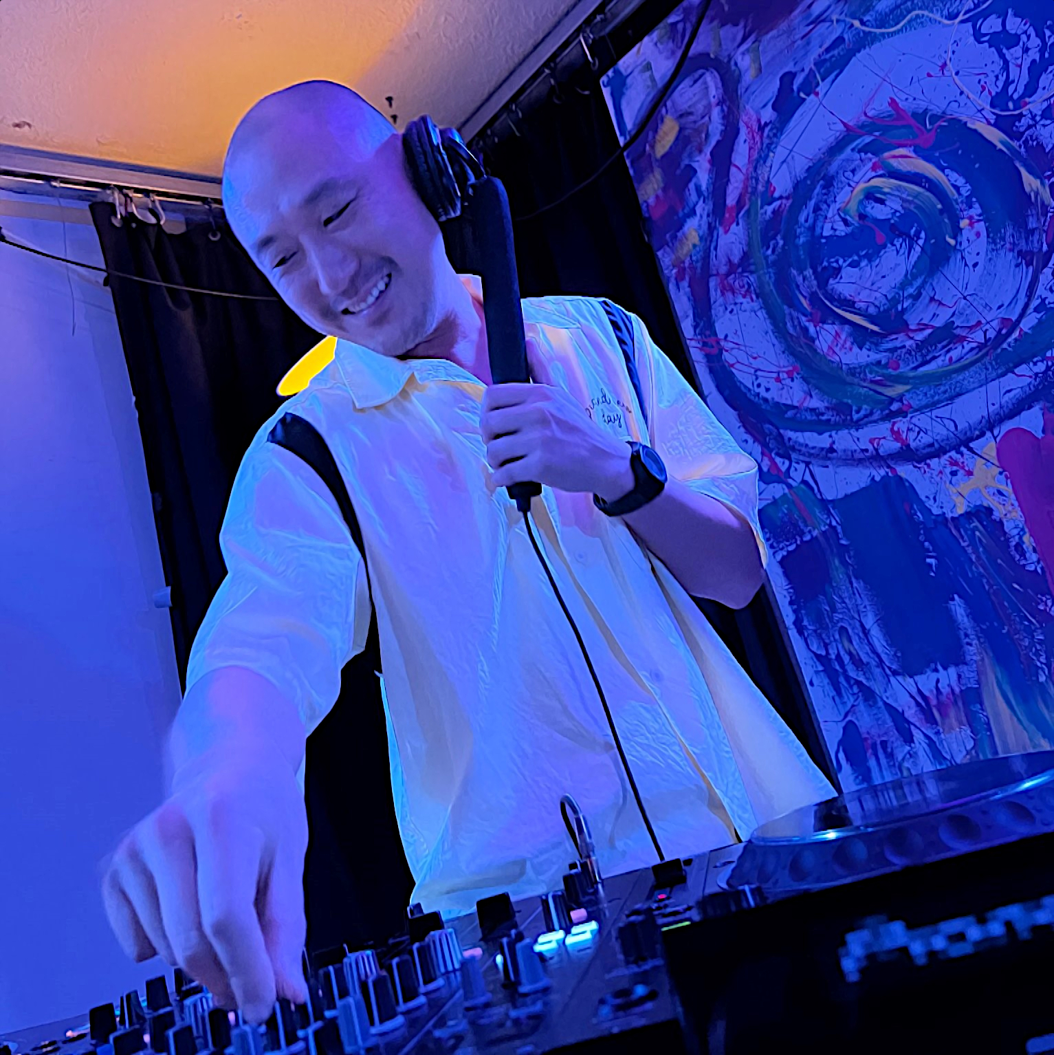 Taiwanese DJ and producer Murphy Kin performing at an event in blue lighting, colour image.
