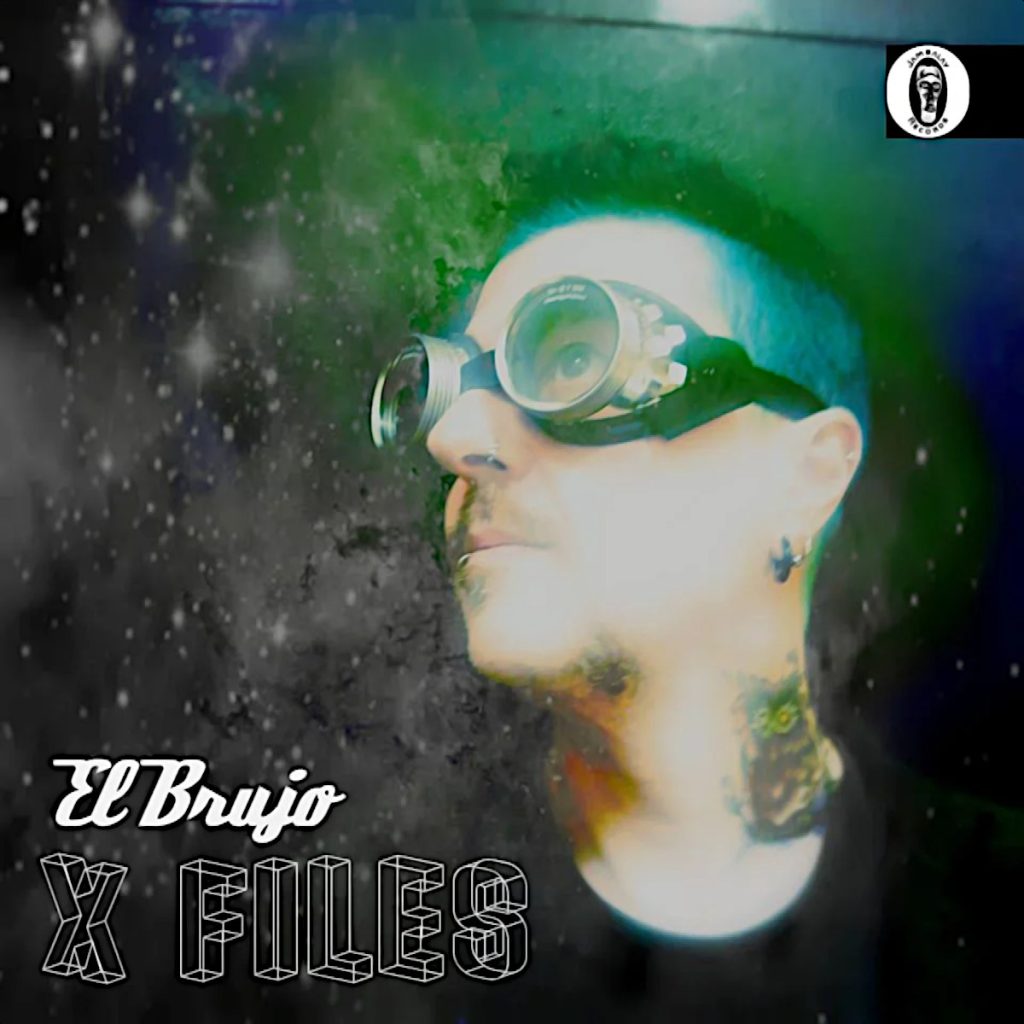 Italian DJ and producer El Brujo standing looking up to right wearing goggles on the X files release cover for Jambalay Records, colour image.
