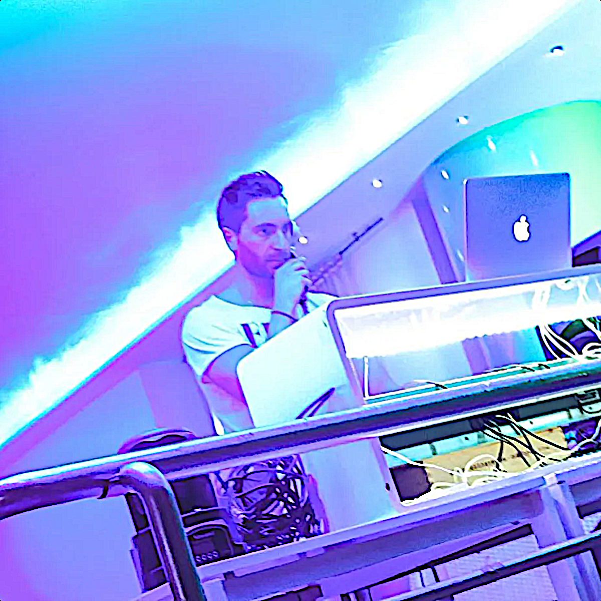 Italian DJ and producer INVE performing at an event, colour image.