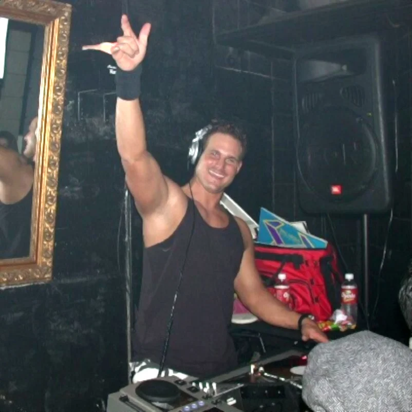 American Dj Jim Bradley performing in Dallas, U.S.A with his right hand raised, colour image.