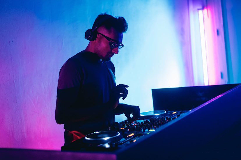Singaporean DJ Sivanesh performning at The Council in Singapore on Pioneer CDJs, colour image taken at 45 degrees.