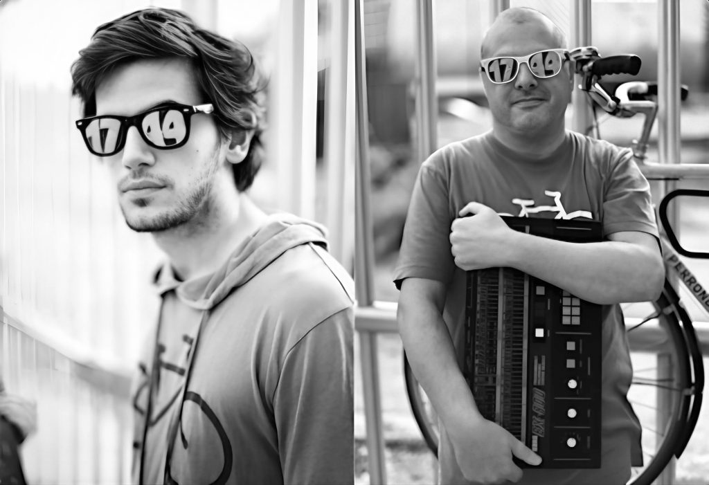 Stefano Ugliano and Marco Mei (Bicycle Corporation) Standing wearing Sunglasses in front of gate in a split photo, black and white