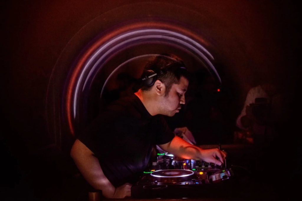 Indonesian DJ Nandi performing at an events in Jakarta on Pioneer CDJs, colour image.