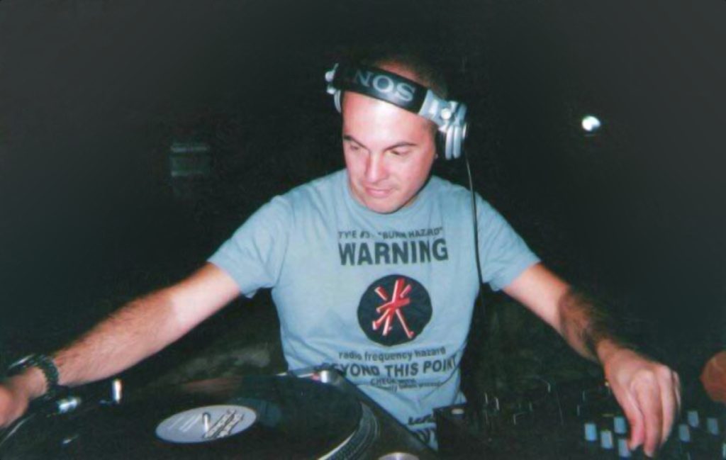 Italian DJ and producer Marco Mei performing as a DJ at Pacha Egypt, colour image.