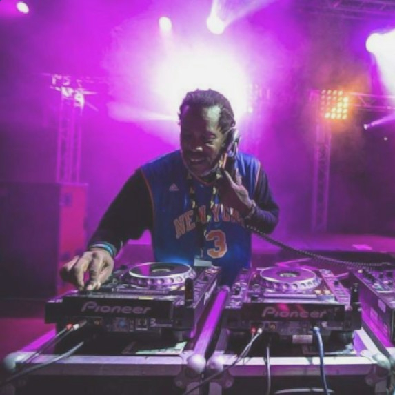 British DJ and producer Bert Bevans performing in Asia on Pioneer CDJs and DJM 800 Mixer, purple lighting.