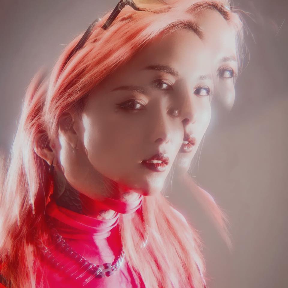 Taiwanese DJ and producer HER (叫小鶴) in a stylised portrait with soft lighting and double exposure effect, wearing a red outfit and looking toward the camera.