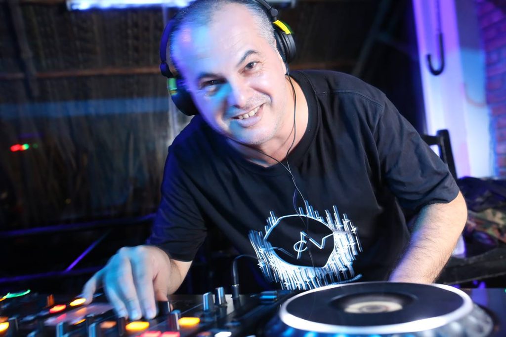 Italian DJ and producer Marco Mei performing as a DJ on Pioneer CDJs at Line Up Bar, Mui Ne, colour image.