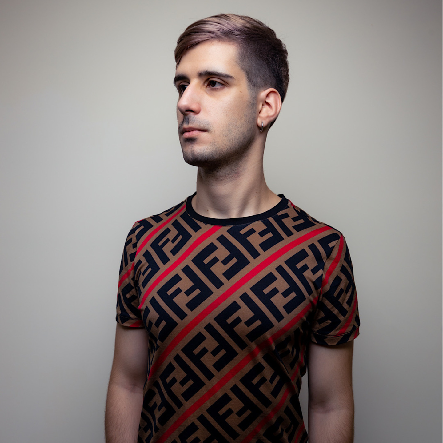 Italian DJ and producer Giorgio Leone standing and looking right, colour image.