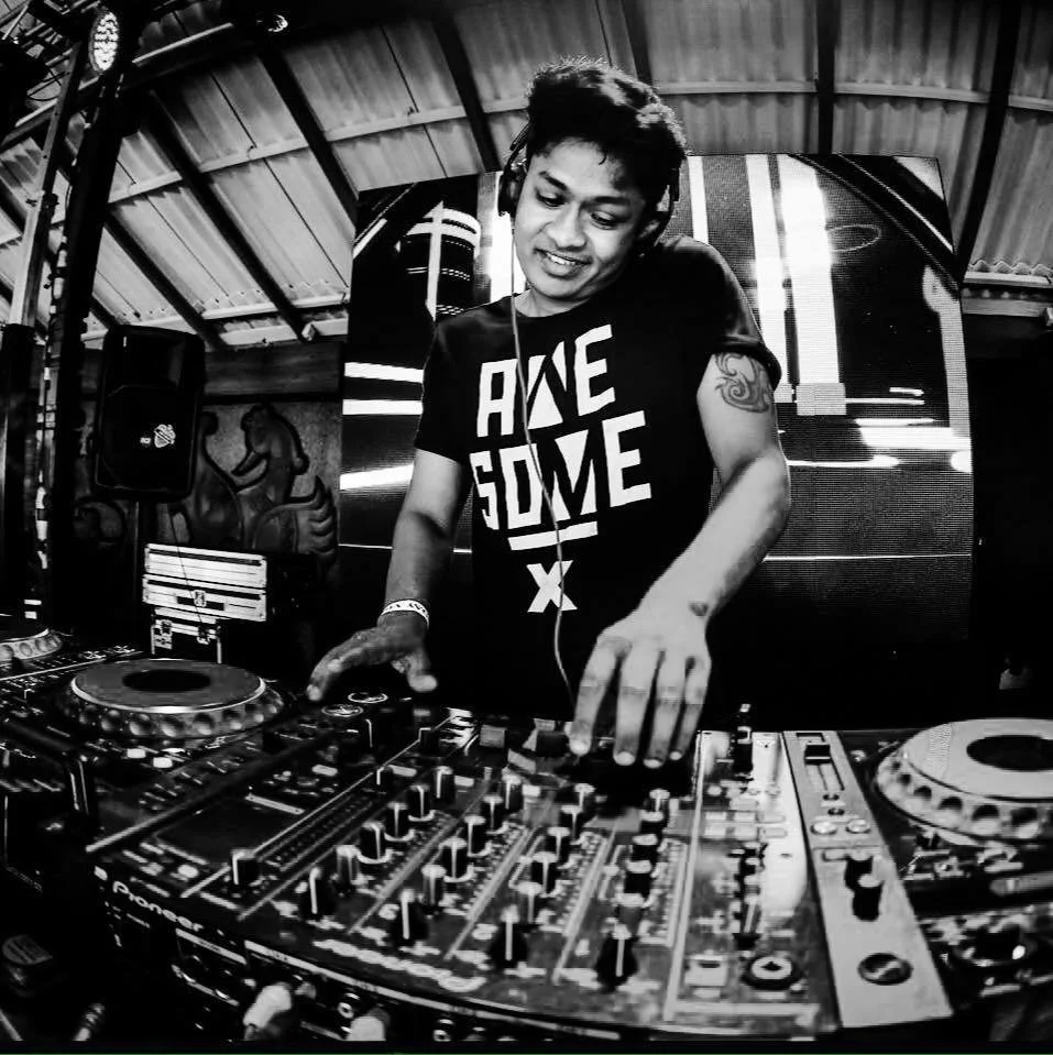 Sri Lankan DJ Soulhunter performing on Pioneer DJM 900 and CDJs, black and white image.