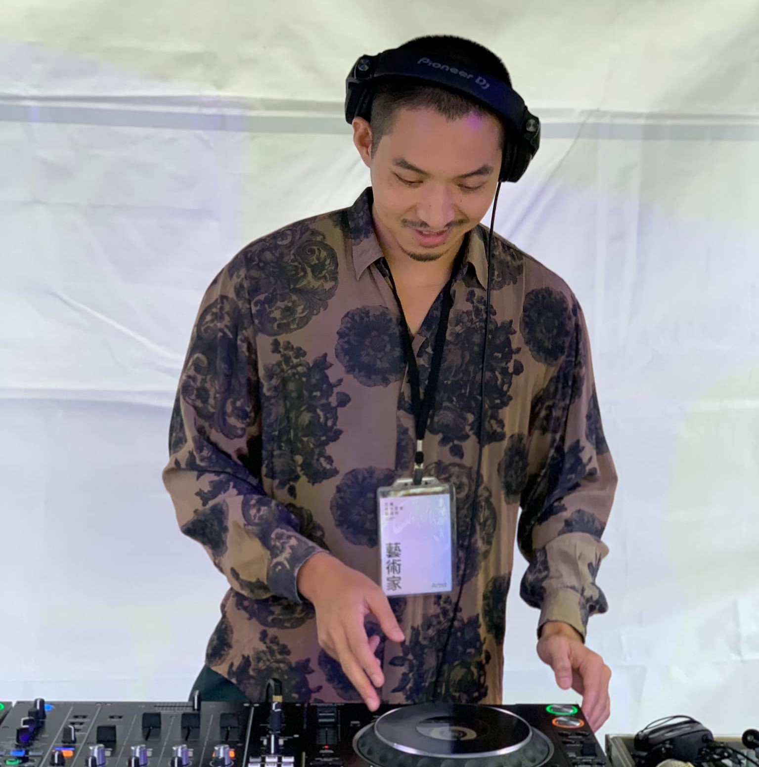 Taiwanese DJ and Promoter Jesse Chen performing on Pioneer DJ Equipment at an event, colour image.