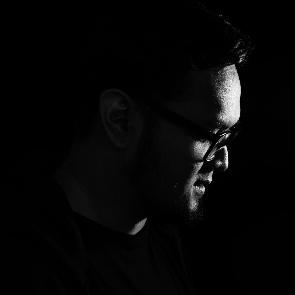 Indonesian DJ and producer Yorri stading looking left in a dark black and white image of his head.