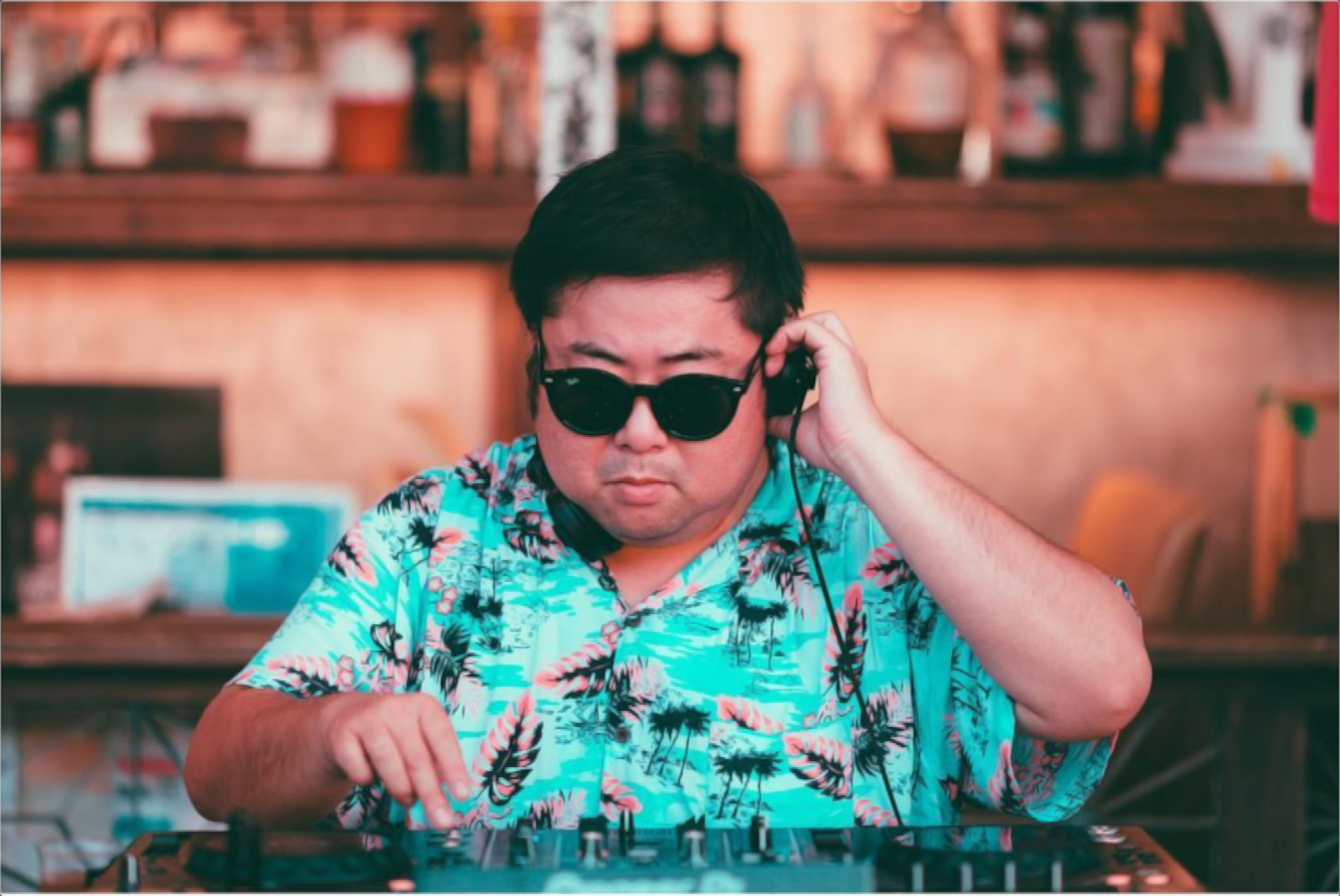 Japanese DJ Marcy performing at an event, colour image.