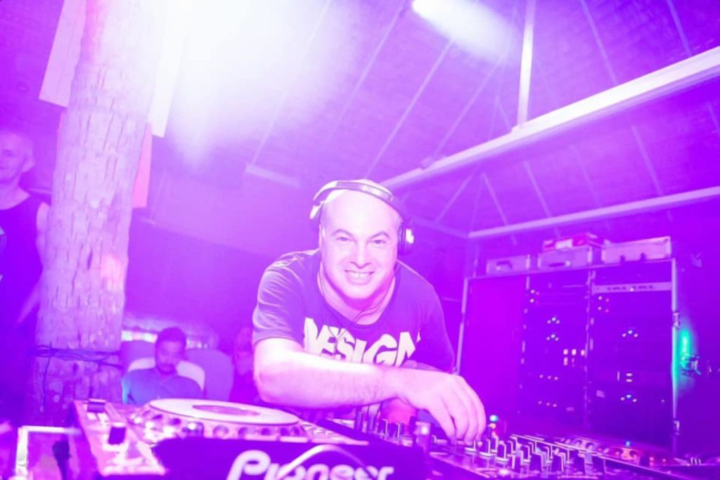 Italian DJ and Producer Marco Mei performing at Half Moon Festival, Thailand, colour picture with purple lighting.