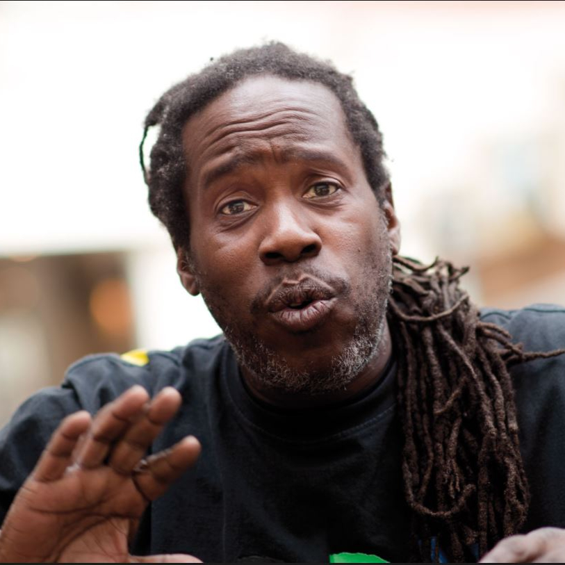 American DJ and producer Bert Bevans speaking with his hand raised, colour image.