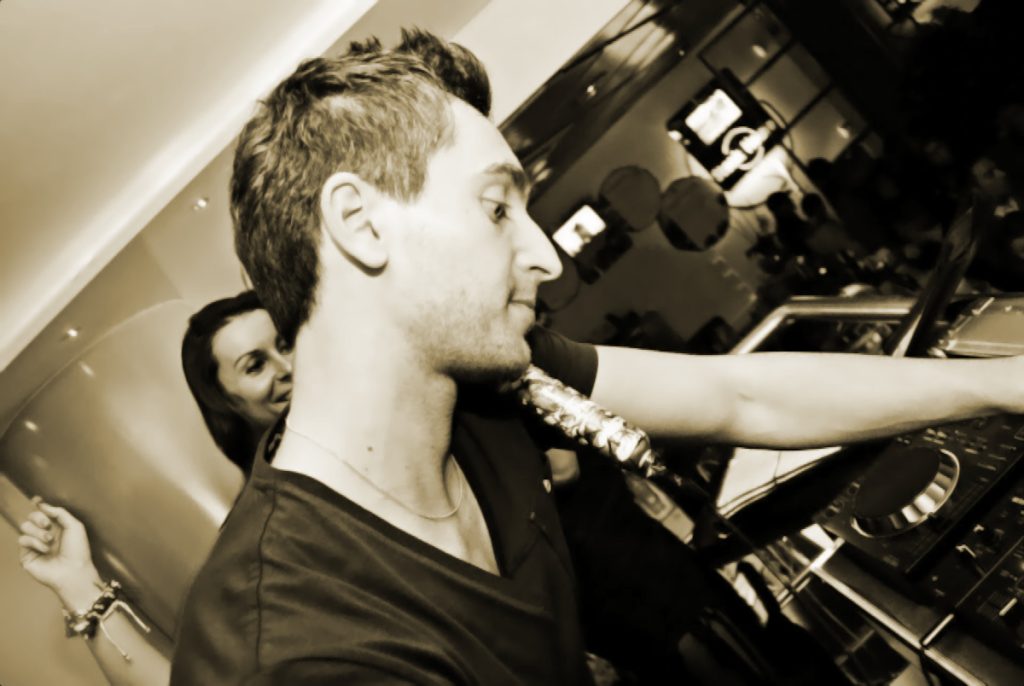 Italian DJ and producer INVE performing at iBar in Italy, Black and White image with beige tinge.