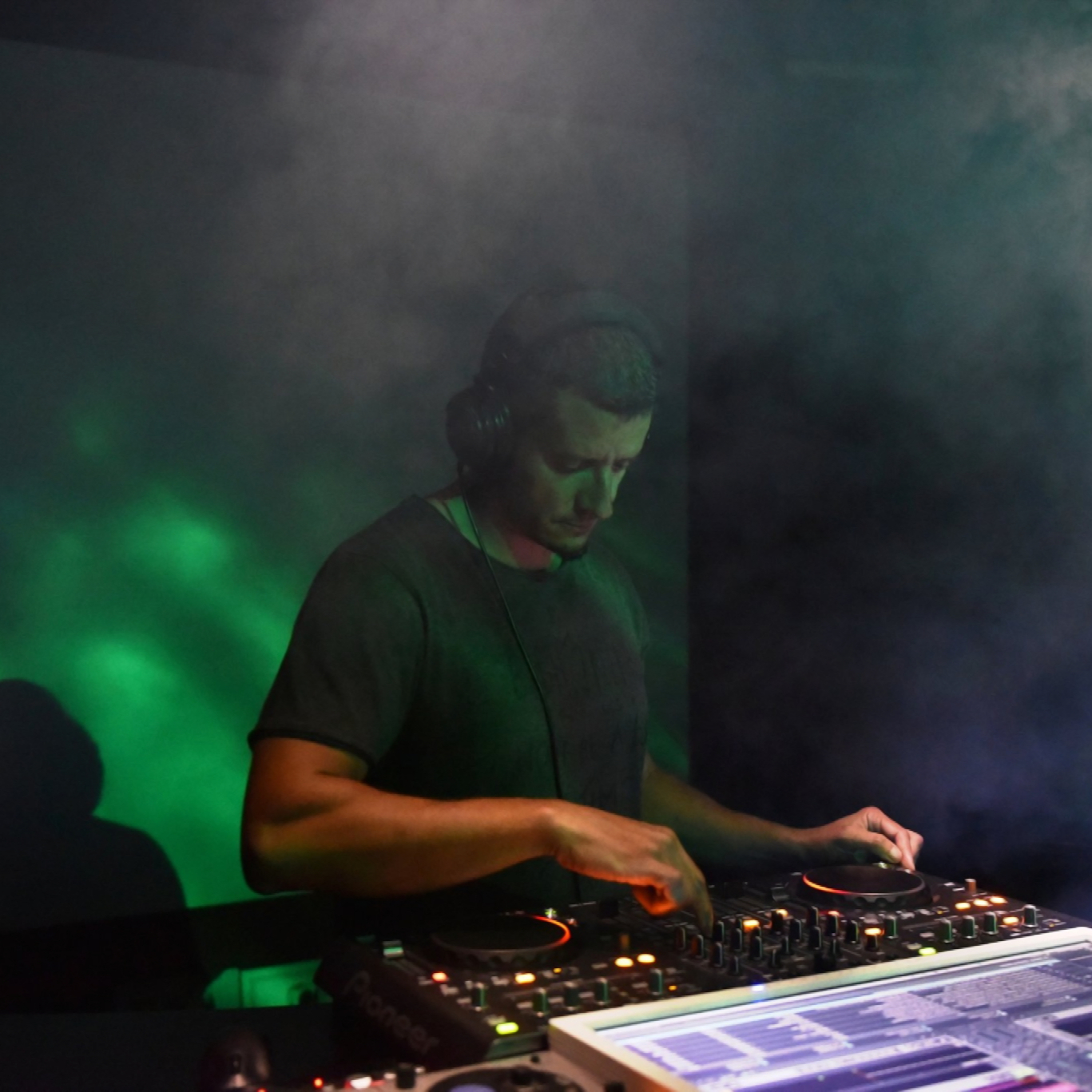 Hungarin DJ and producer Kay-D performing at an events in a nightclub, colour image.