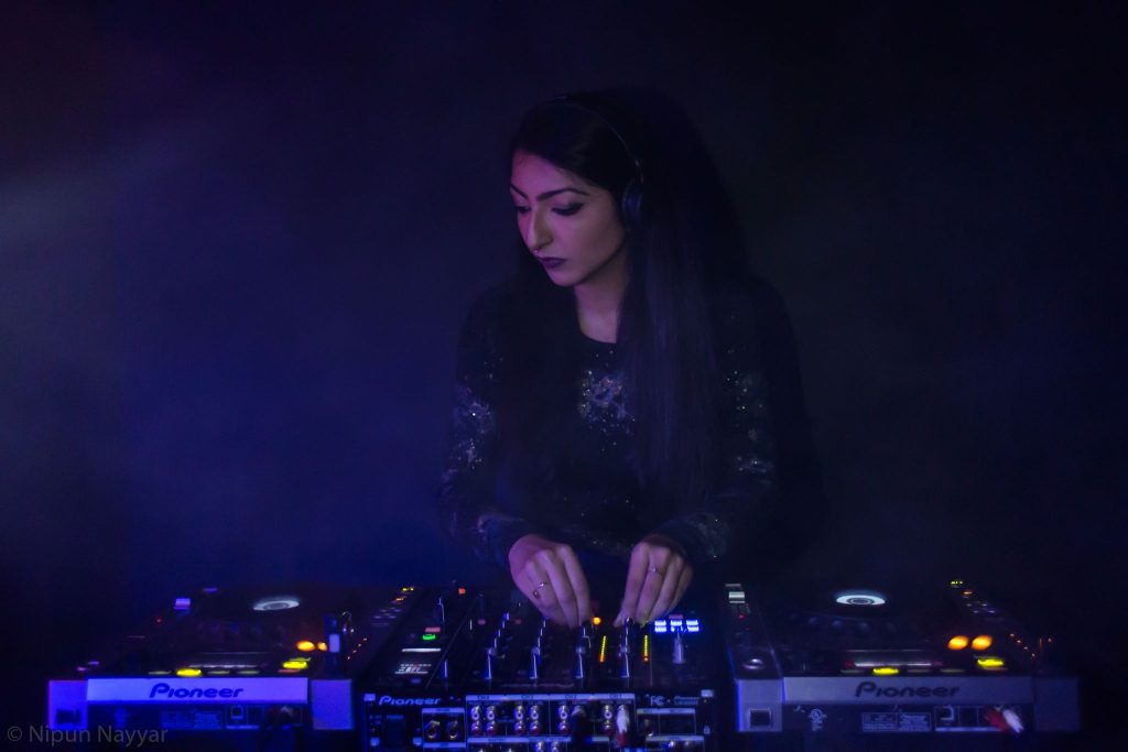 French DJ and Producer Rimka performing at an event, colour image.