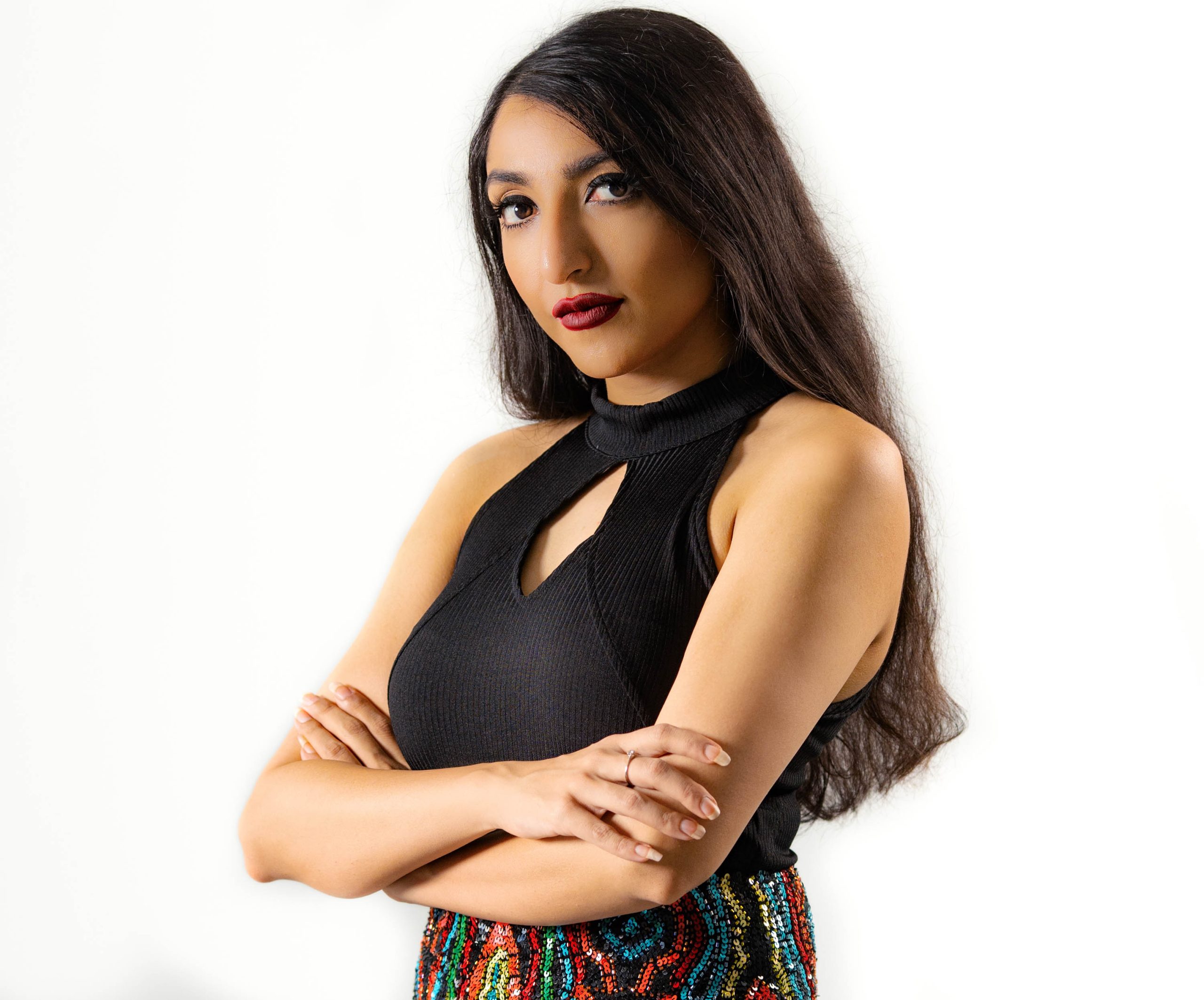 French DJ and producer Rimka standing with arms crossed looking at camera, colour image.