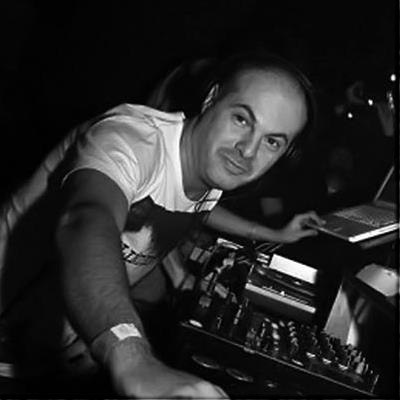 Marco Mei Leaning on Mixing desk in front of laptop in Studio
