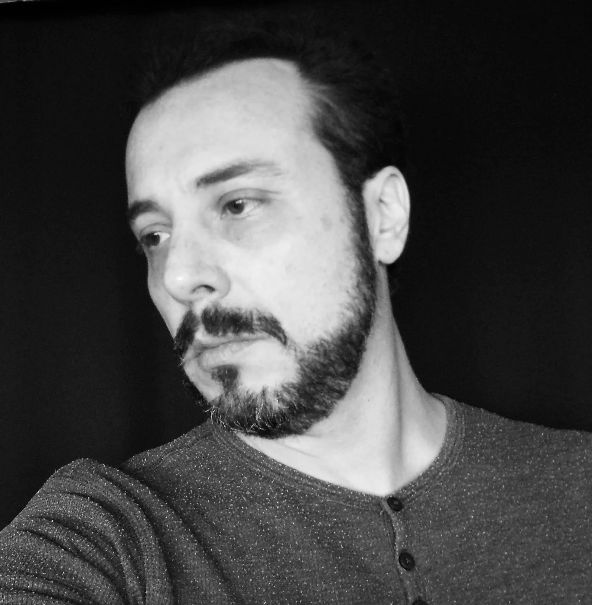 Colombian DJ Andres Fierro looking right in upper body shot, black and white image.