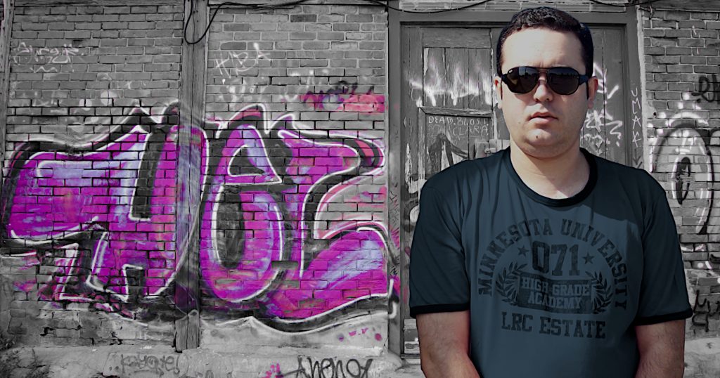Portuguese DJ Jposhua Standing in front of Graffiti on a wall in Portugal, colour image.