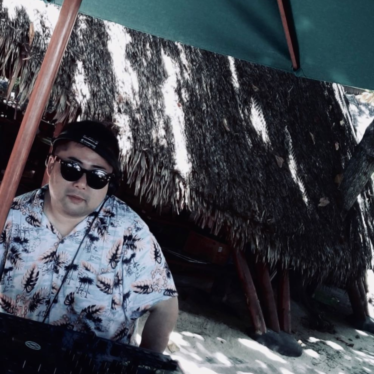 Japanese DJ Marcy performing at a beach event, colour image.