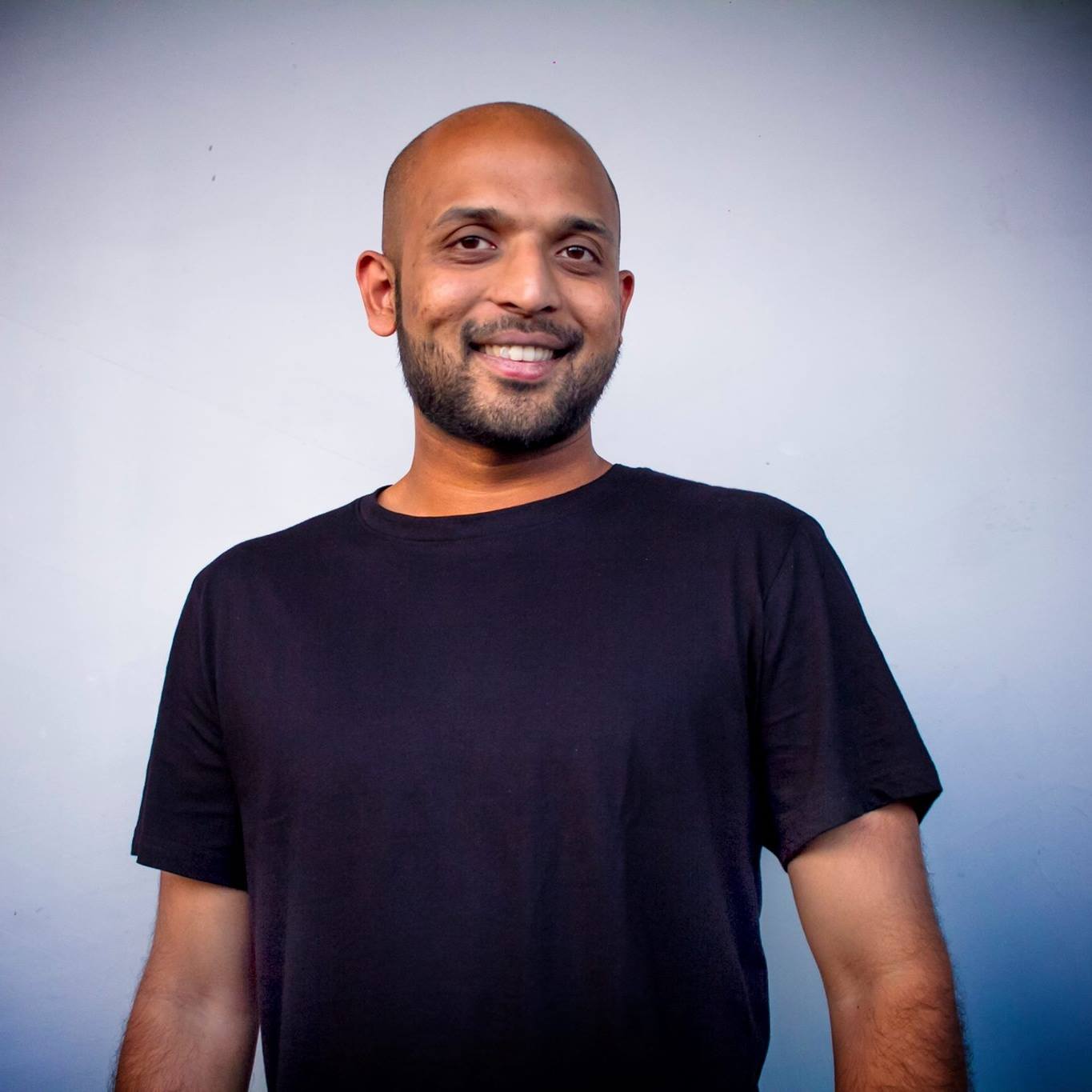 Indian DJ and producer Weird Sounding Dude standing looking at camera, colour image.
