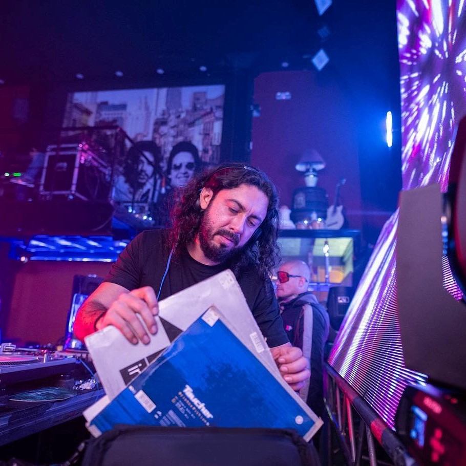 Colombian DJ and producer Mauro Aguirre performing at an event at home colour image.