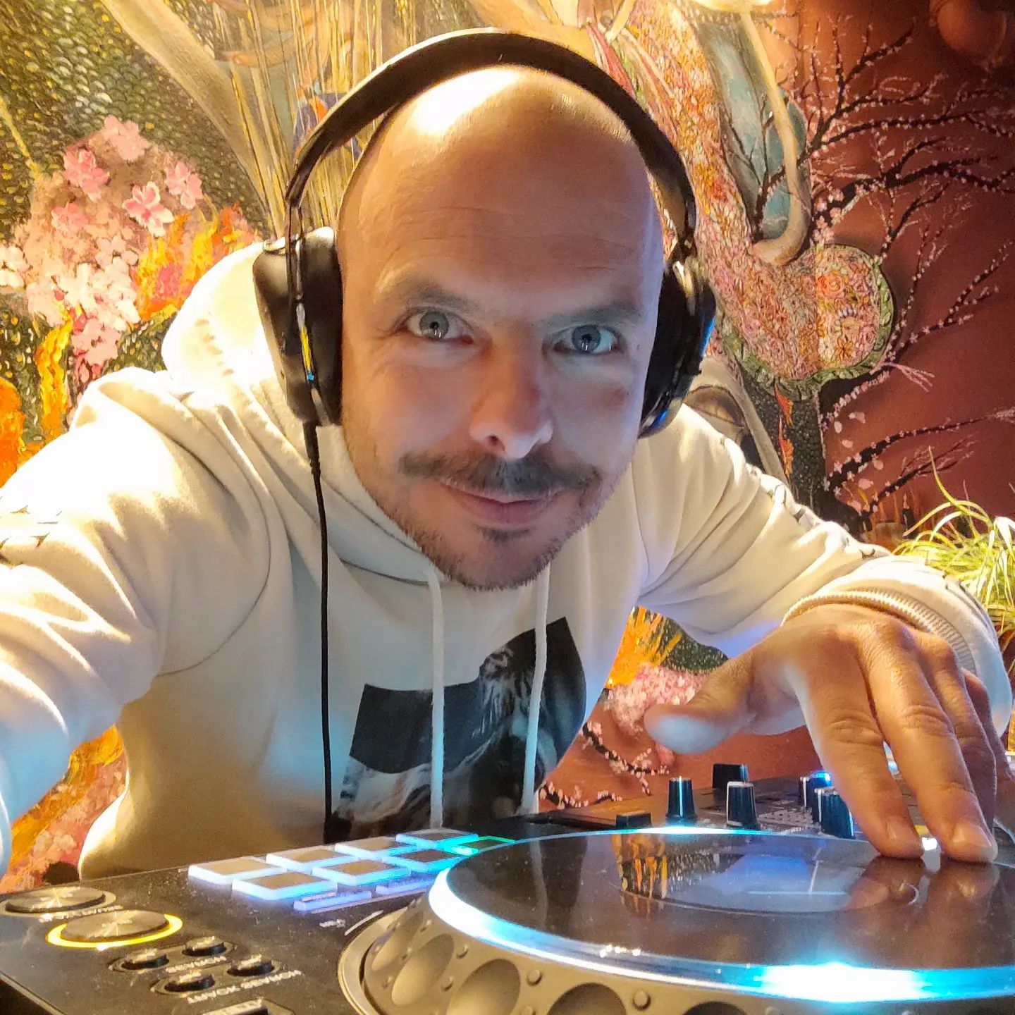 Colombian DJ and Producer Golan Zocher posing with his hand on turntable, colour image.