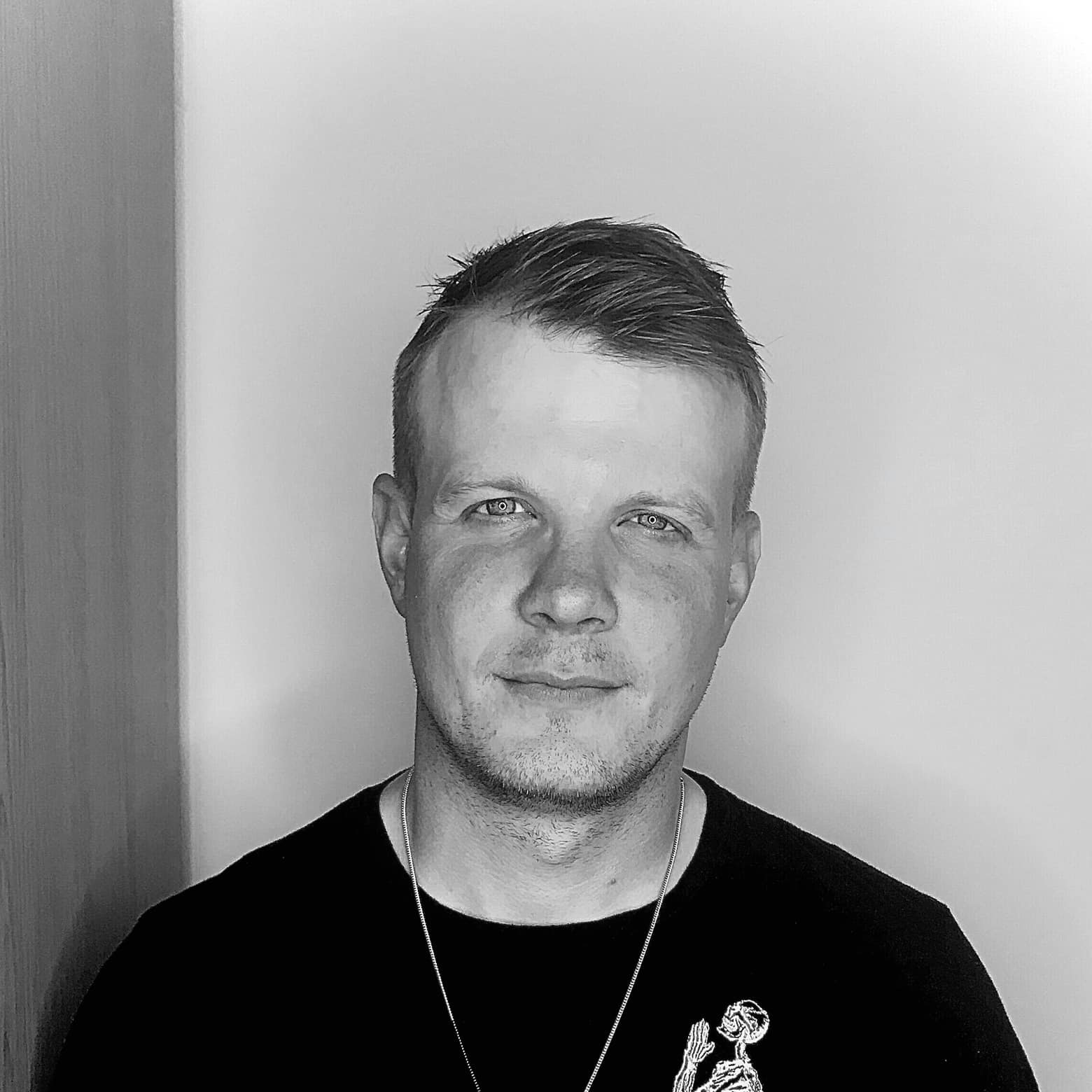 London based DJ and Producer Sebastian Haas posing for camera, black and white image.