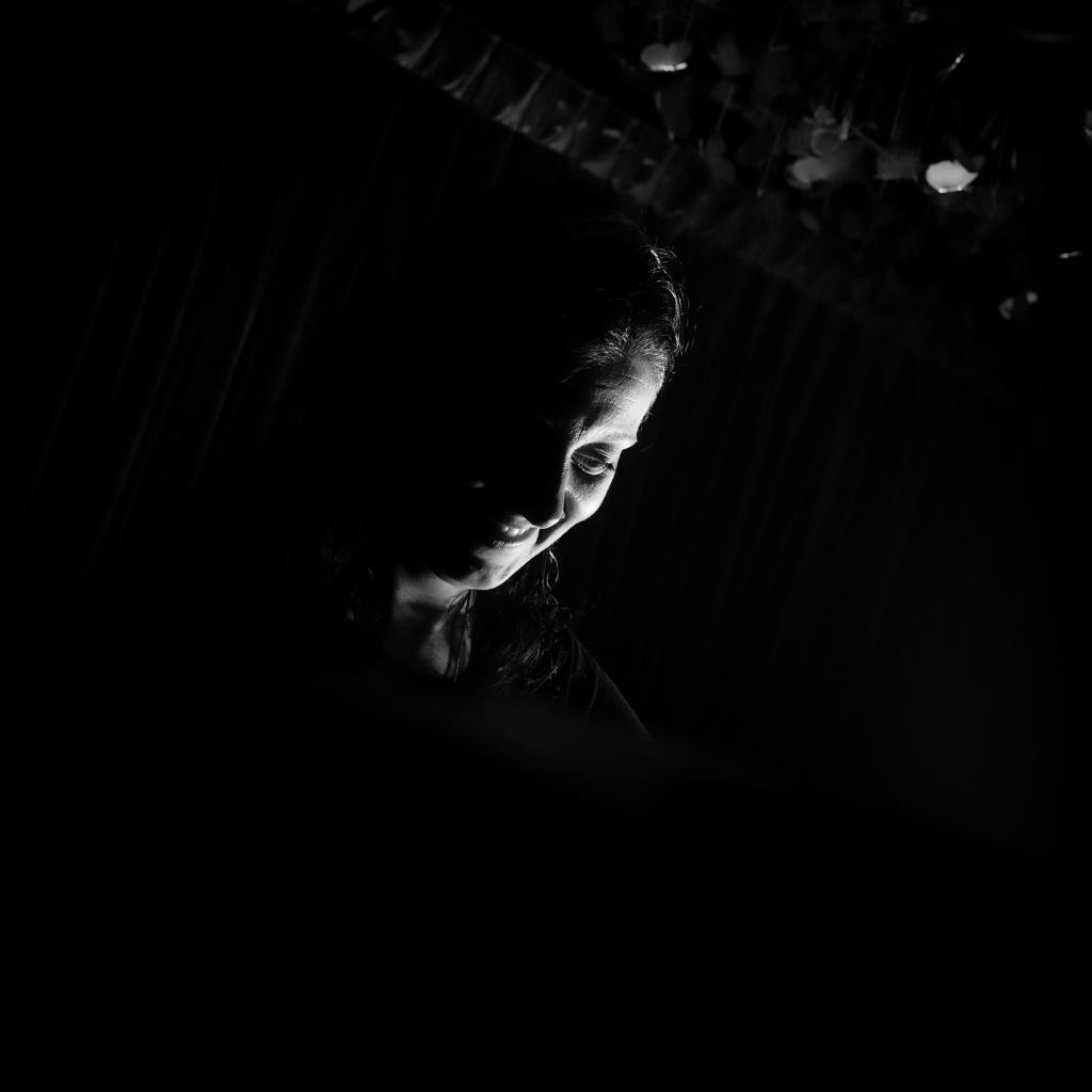Romanian DJ and promoter DJ Biscuit performing at an event in darkness, blcack and white image.