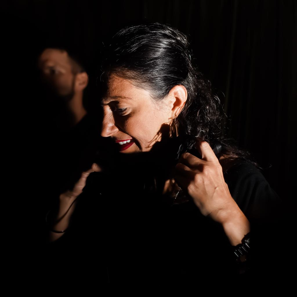 Romanian DJ and Promoter Biscuit performing at an event, colour image.