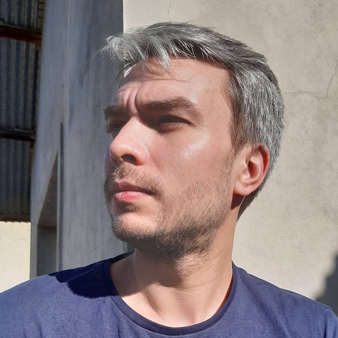 Argentinian DJ and Producer Alan Cerra in head shot looking right, colour image.