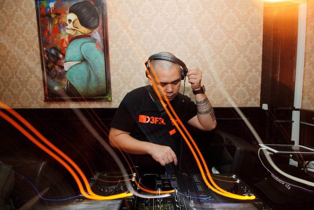 Filipino DJ Patrick Marte performing at a venue in Manila, colour image.