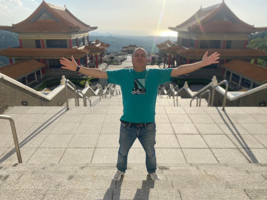Italian DJ and producer Marco Mei standing at top of stairway outdoors in Taipei, colour image.