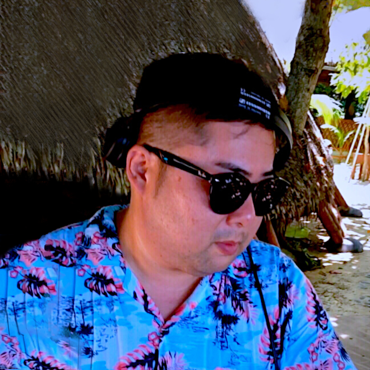 Japanese DJ Marcy performing at a beach event, colour image.