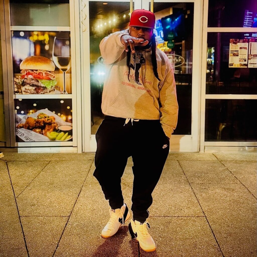 Baltimore Hip Hop artist Jay Royale wearing a red cap and hoodie.