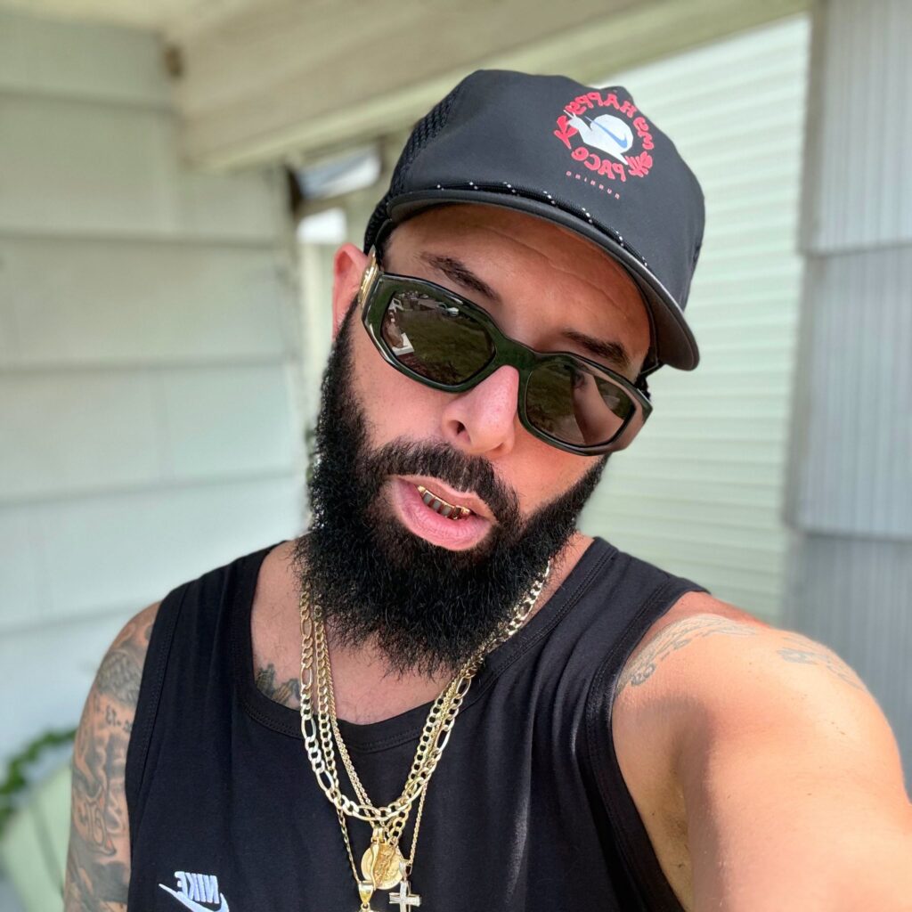 Copywrite, American underground Hip Hop rapper and Mixtape Addict guest, wearing sunglasses and a black cap.