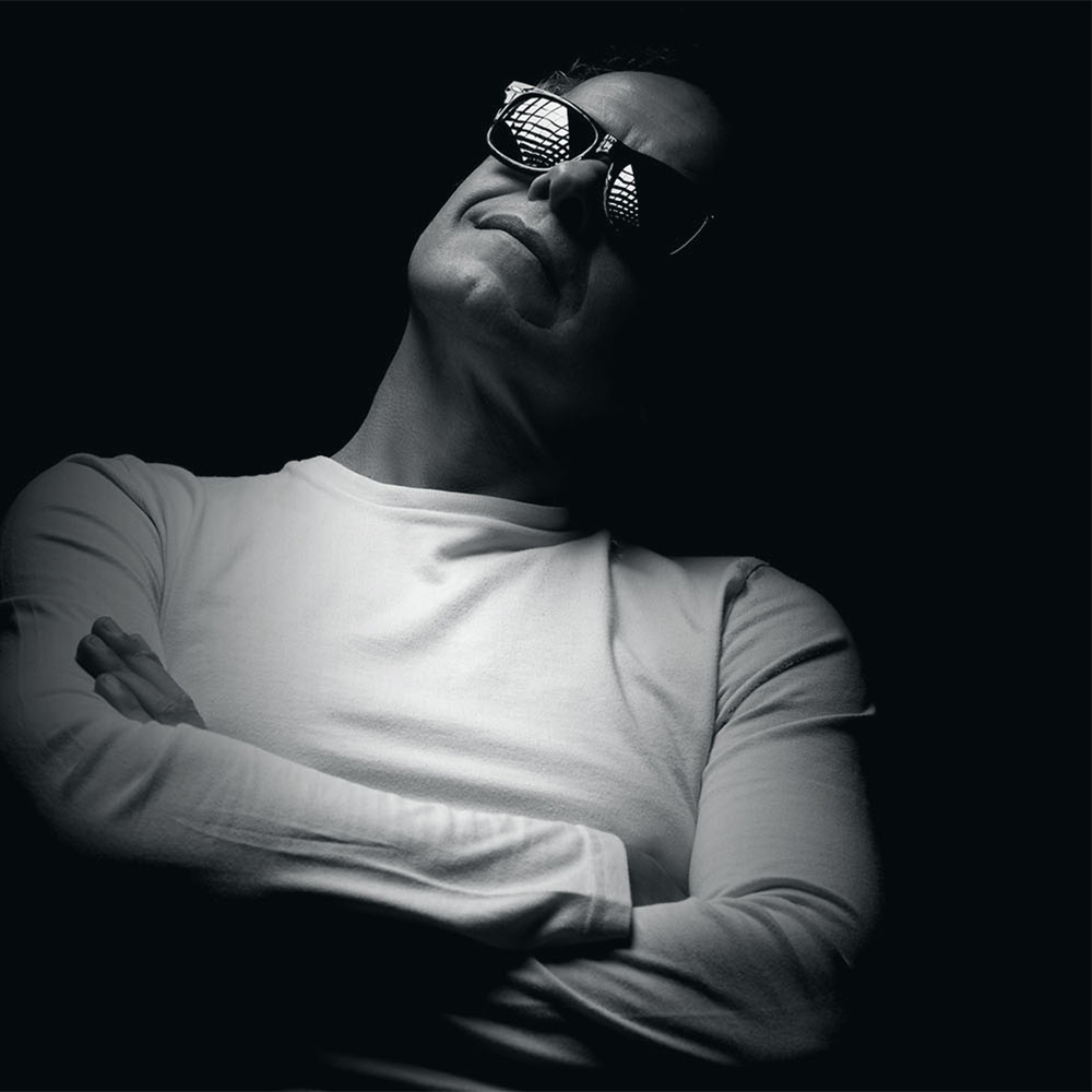 Italian DJ Ezio Vallini, known as DJ Valez, in a black-and-white portrait.