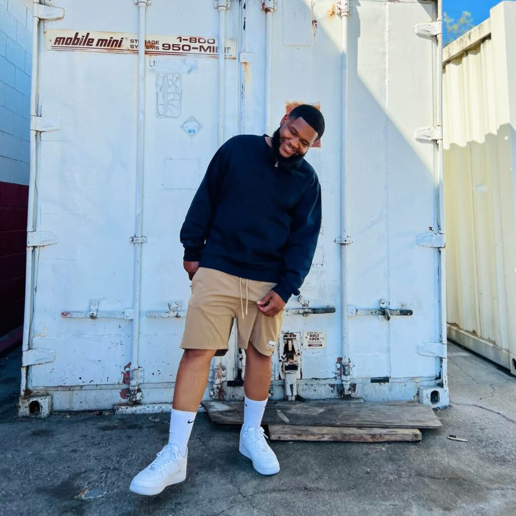 Memphis rapper Heartbreak JC posing outdoors in front of a white shipping container.