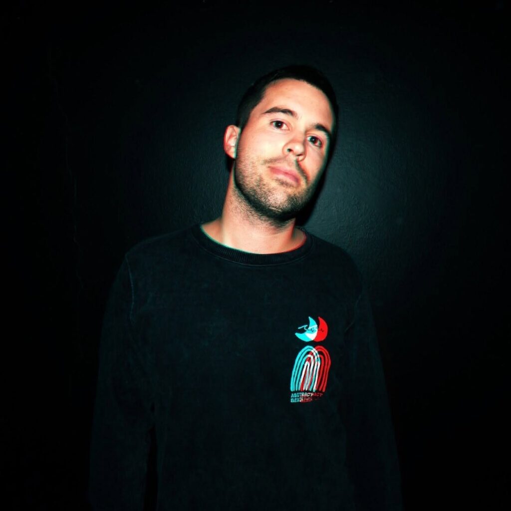 Juan Arcucci, Argentine Progressive House DJ and producer, in a dark portrait.