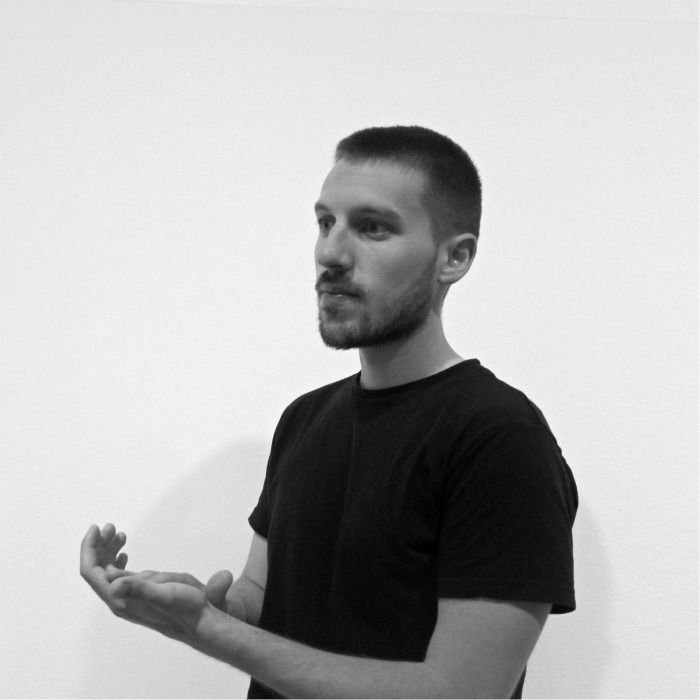 Adrian Roman standing rubbing hands together.